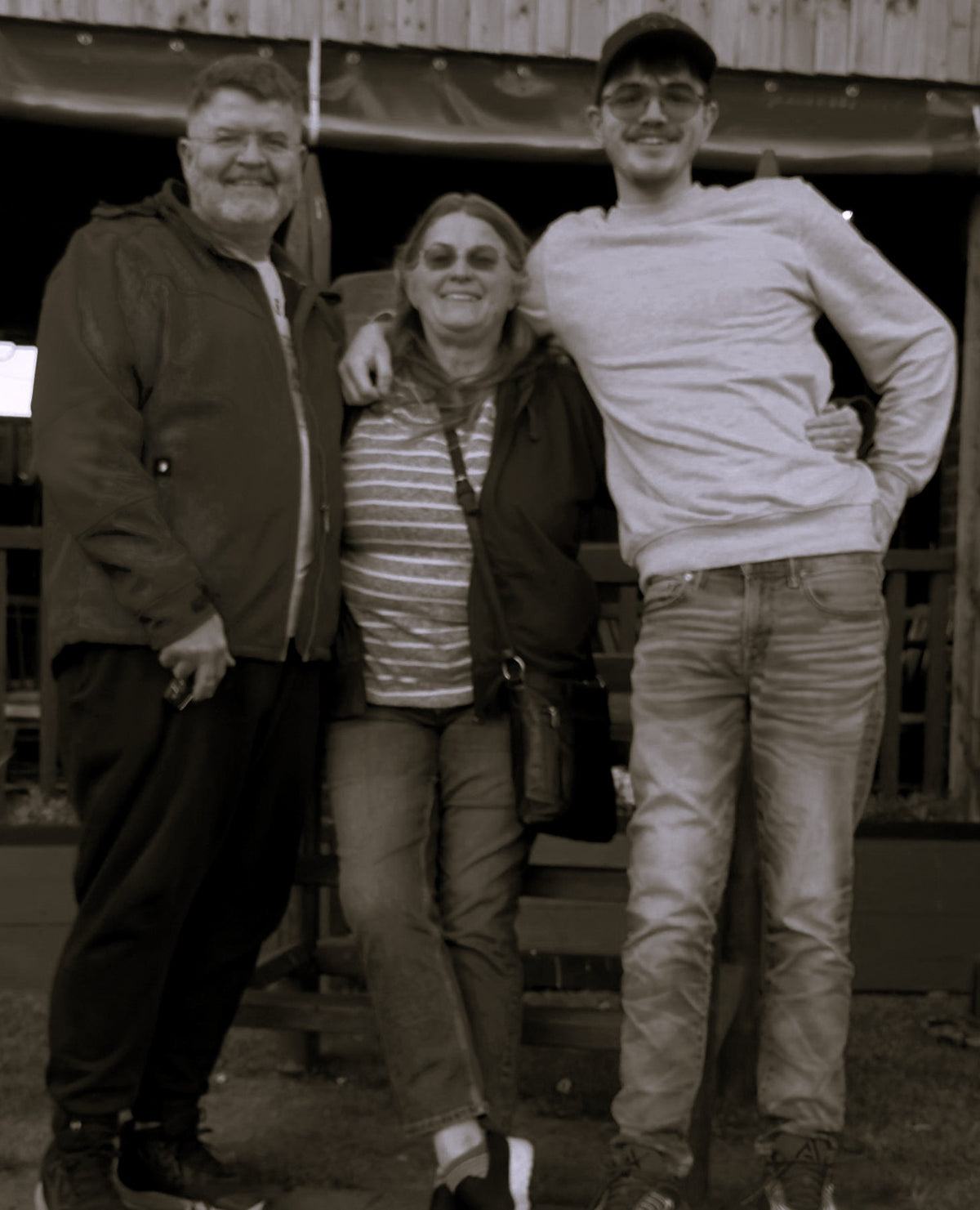 Three people, Nico, Susan, and Noah,  standing together outdoors, posing for a photo.