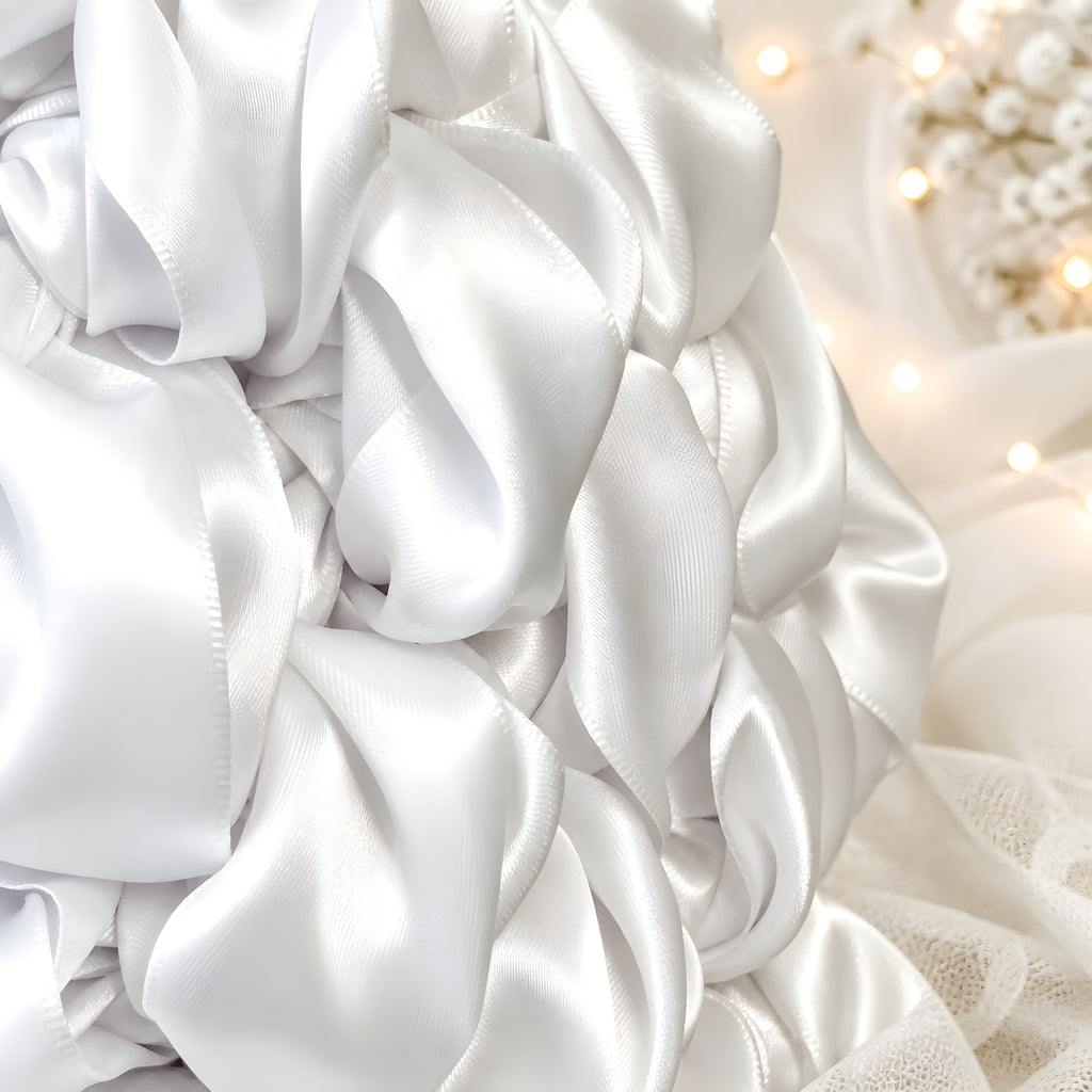 Close-up of white SATIN CrOCHET BAG with a textured pattern, soft focus background
