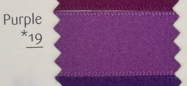Close-up of purple fabric swatch labeled 'Purple *19' on a white background