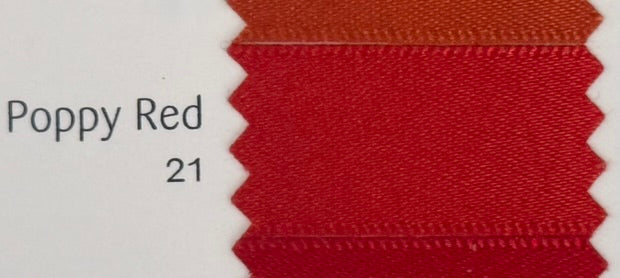 Close-up of a fabric swatch labeled 'Poppy Red 21' on a white background