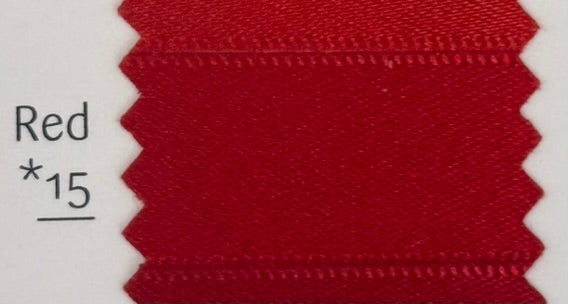 Close-up of red fabric with a label indicating color code 'Red *15'.