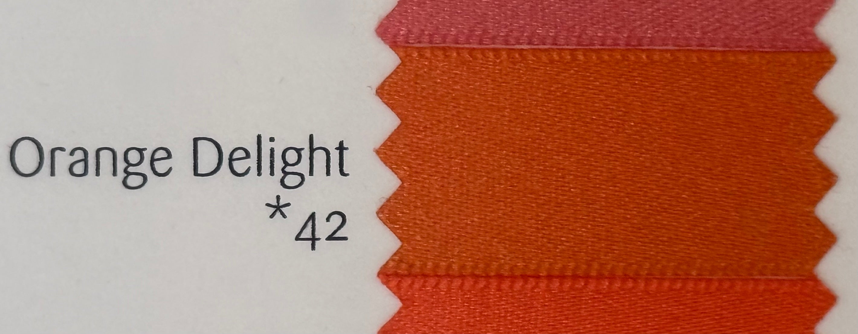 Fabric swatch labeled 'Orange Delight *42' on a white background