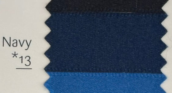 Navy blue fabric swatch with a label indicating the color name and number.