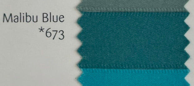 Textile swatch with 'Malibu Blue *673' label on a white background