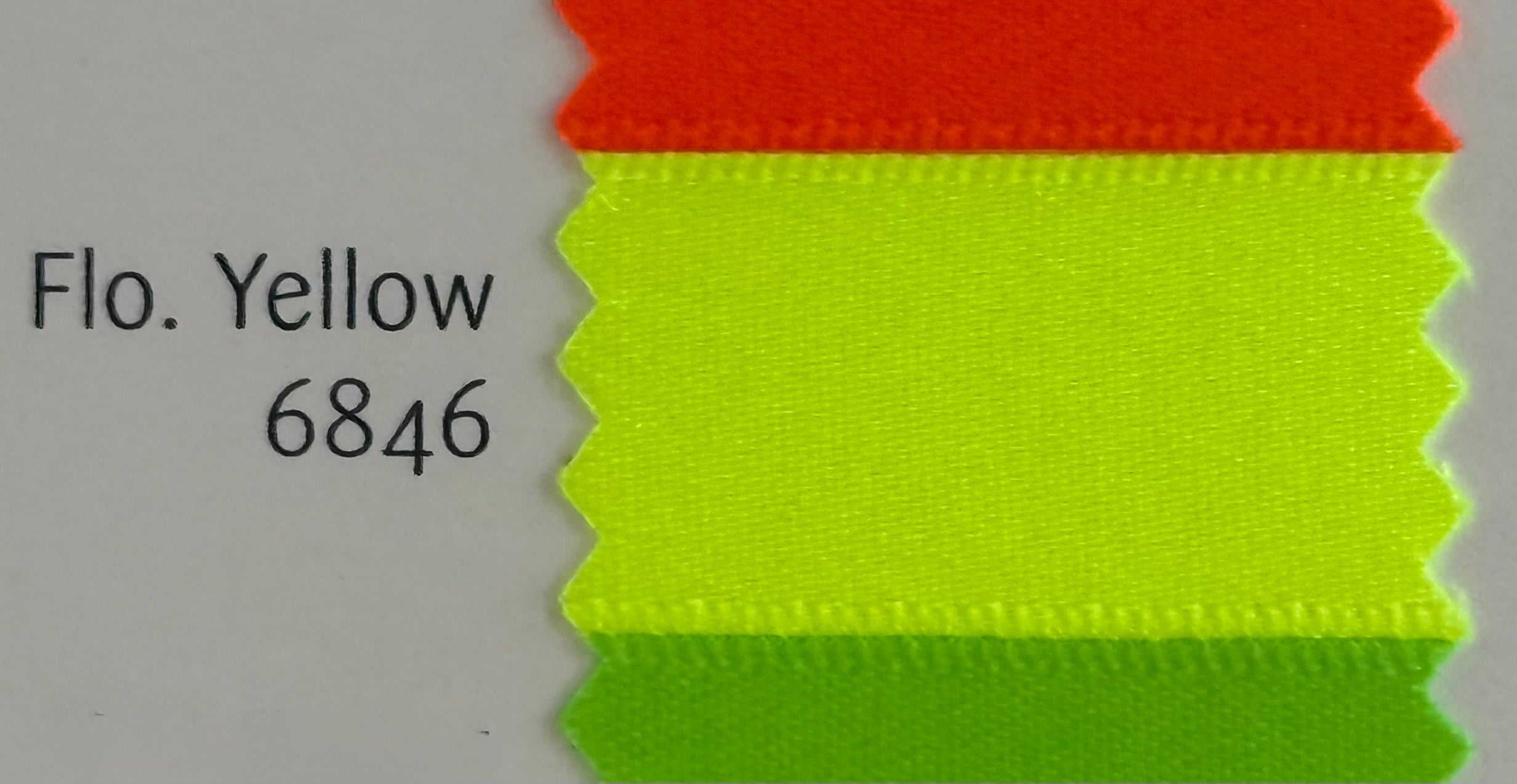 Color swatch with red and green fabric swatches labeled 'Flo. Yellow 6846' on a gray background.